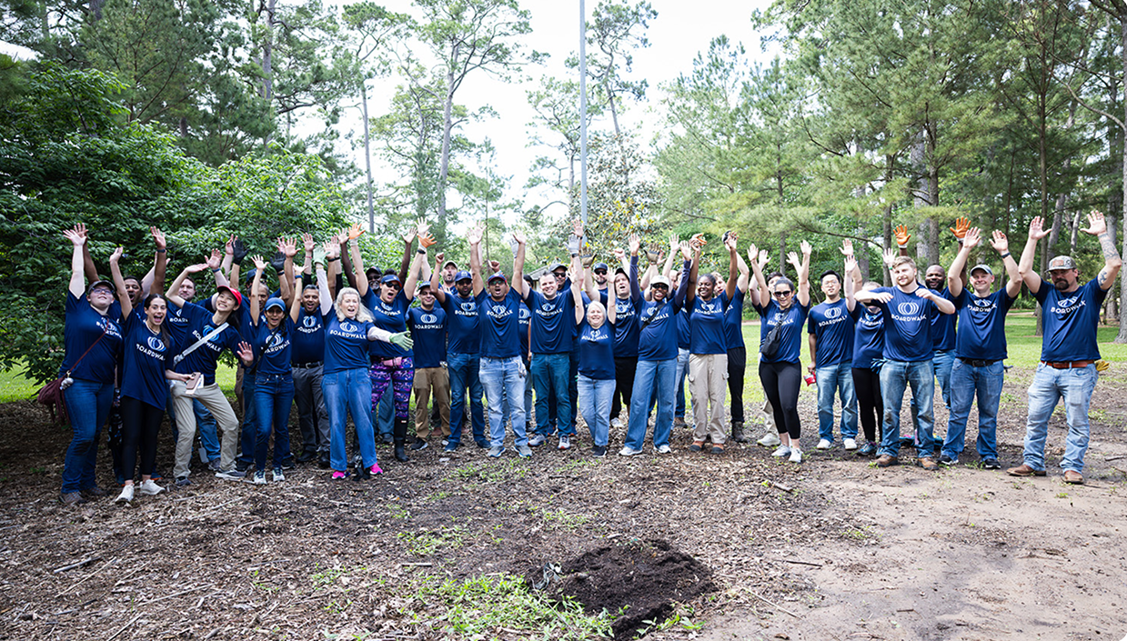 Boardwalk employees cheering together at a community volunteering event
