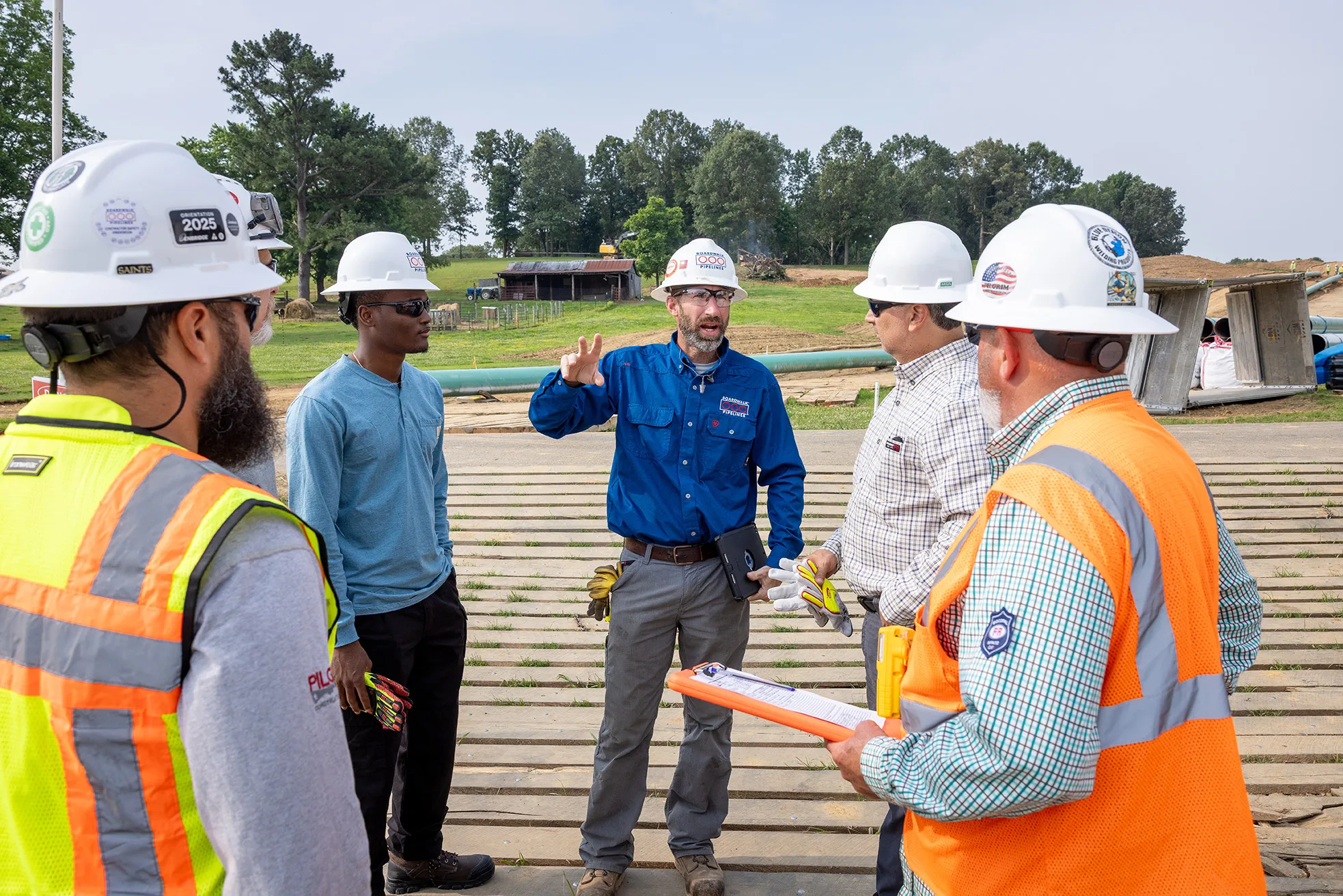 Boardwalk staff and contractors reviewing plans on a work site