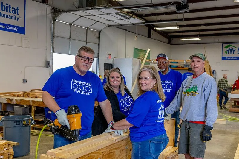 Boardwalk field team gathered inside a maintenance facility